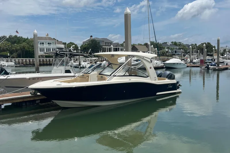 Slide: The Image of 2015 Scout 275 Dorado boat docked in a marina under clear skies. - 3