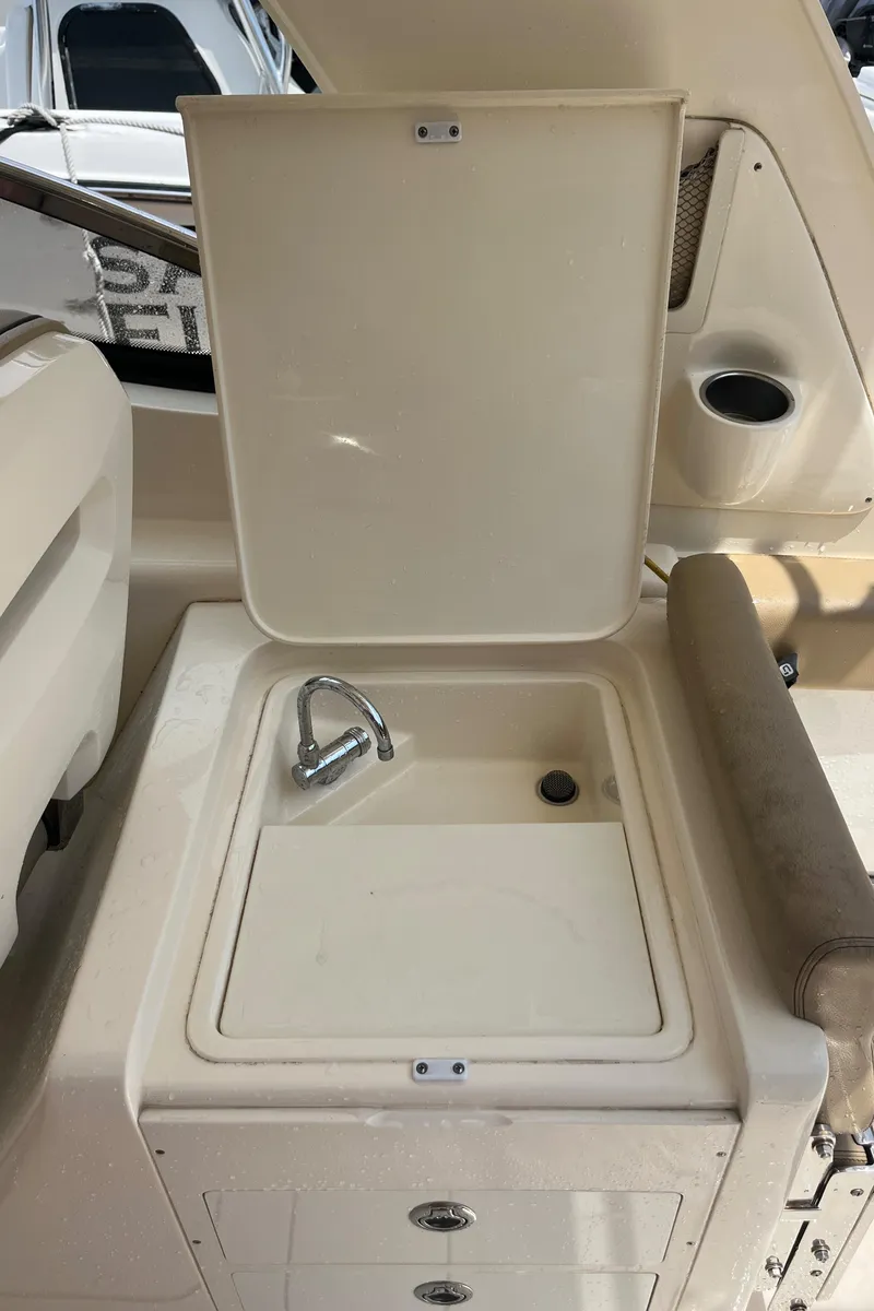 Slide: The Image of 2015 Scout 275 Dorado boat interior with compact bathroom and toilet. - 33