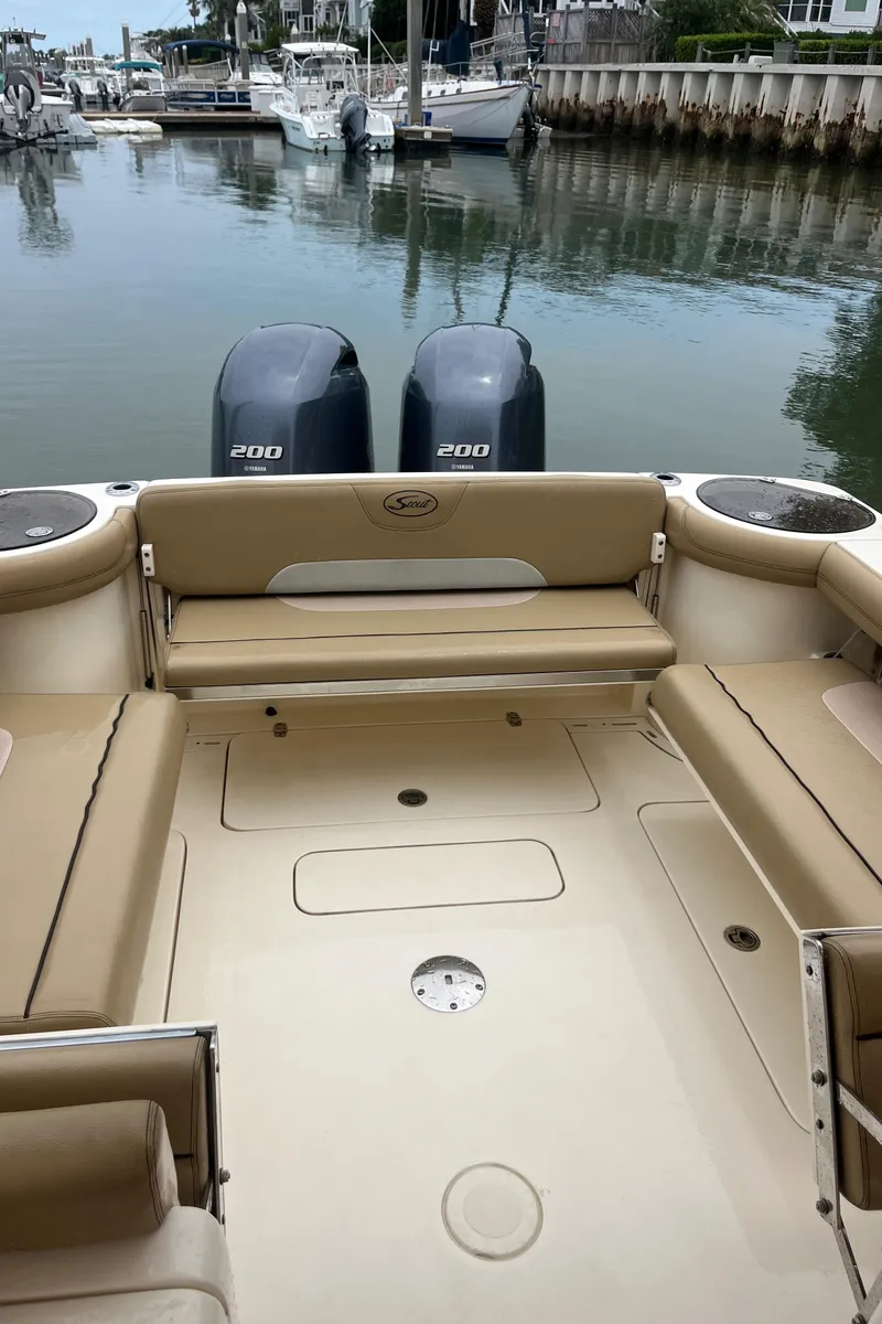 Slide: The Image of 2015 Scout 275 Dorado boat interior with beige seating and helm area. - 37
