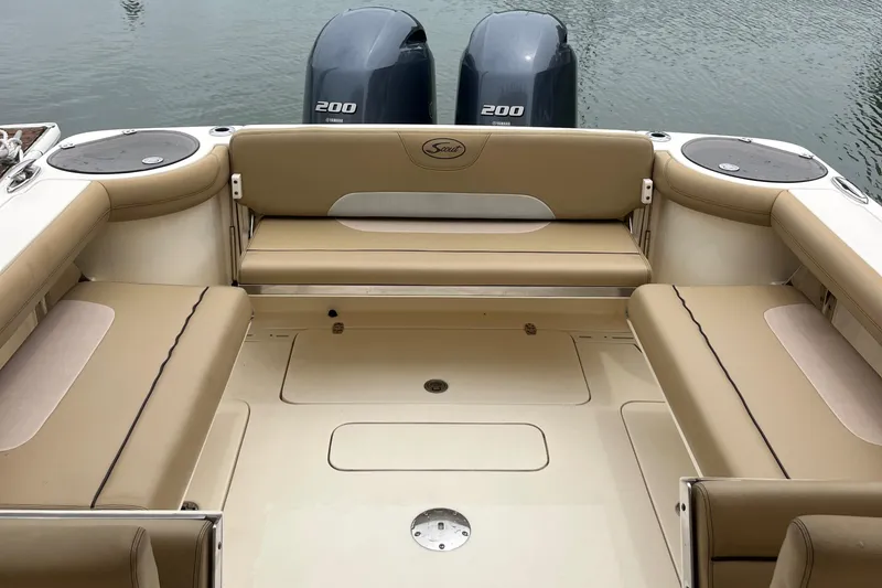 Slide: The Image of 2015 Scout 275 Dorado boat with twin Yamaha outboard engines on calm water. - 38