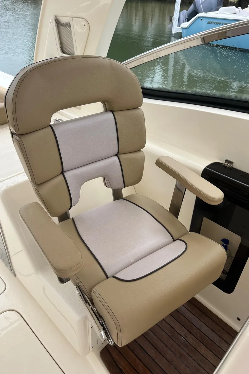 Slide: The Image of 2015 Scout 275 Dorado boat cruising on a sunny day in a marina. - 39