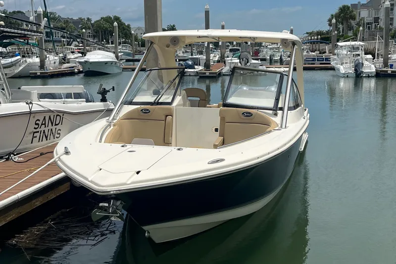 Slide: The Image of 2015 Scout 275 Dorado boat docked at marina, showcasing spacious deck and seating. - 4