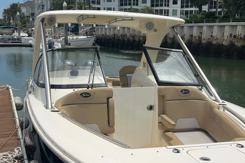 Slide: The Image of 2015 Scout 275 Dorado boat docked at a marina with other vessels. - 6