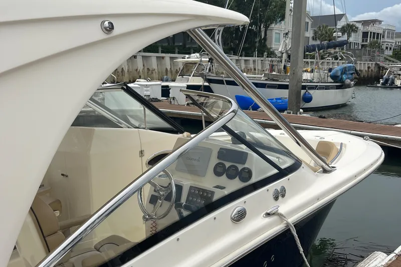 Slide: The Image of 2015 Scout 275 Dorado boat interior with dual engines, beige seating, and storage compartments. - 7