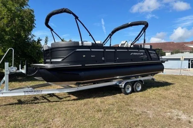 Slide: The Image of 2026 Starcraft SLS 3 R pontoon boat on trailer, parked on grass. - 3