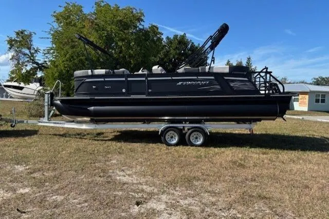 Slide: The Image of 2026 Starcraft SLS 3 R pontoon boat on trailer, parked on grass. - 4