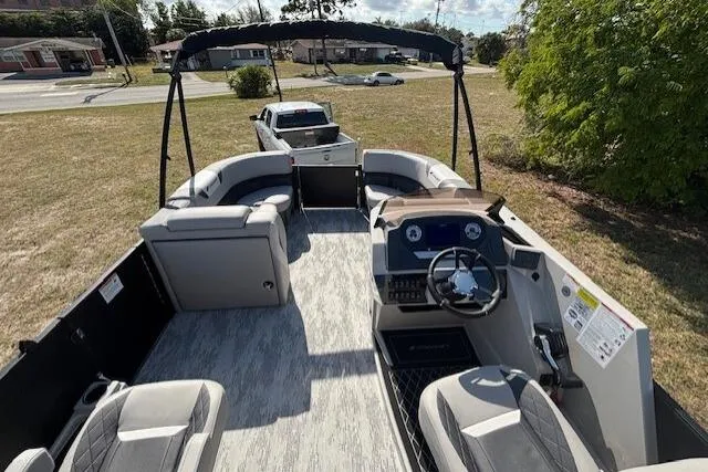 Slide: The Image of 2026 Starcraft SLS 3 R pontoon boat interior with seating and steering console. - 6