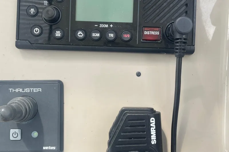 Slide: The Image of Control panel of a 2009 Sea Ray 40 Sundancer boat with Simrad radio and thruster controls. - 14