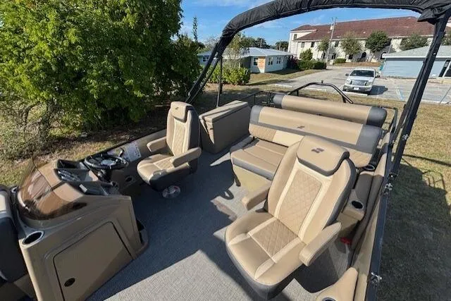 Slide: The Image of 2026 Starcraft EXS 3 DL boat interior with beige seating and steering console. - 10