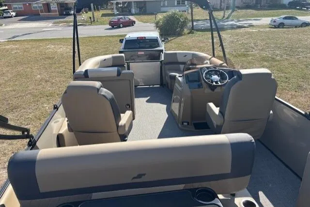 Slide: The Image of 2026 Starcraft EXS 3 DL pontoon boat interior with beige seating and steering console. - 7