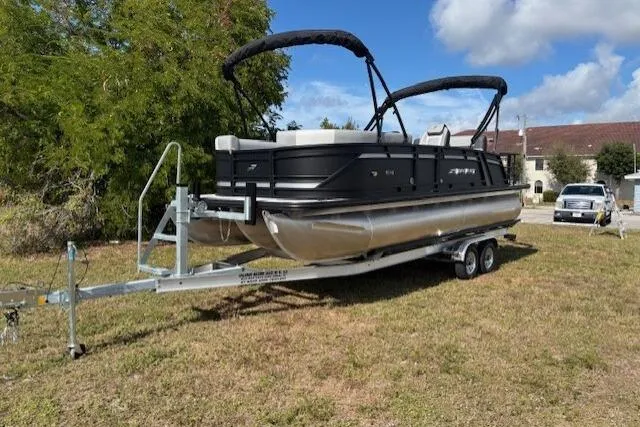 Slide: The Image of 2026 Starcraft EXS 3 Q DH pontoon boat on trailer, parked on grass. - 6