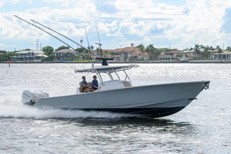 Slide: The Image of 2020 Valhalla Boatworks V-37 cruising on water with two passengers, fishing rods visible. - 9