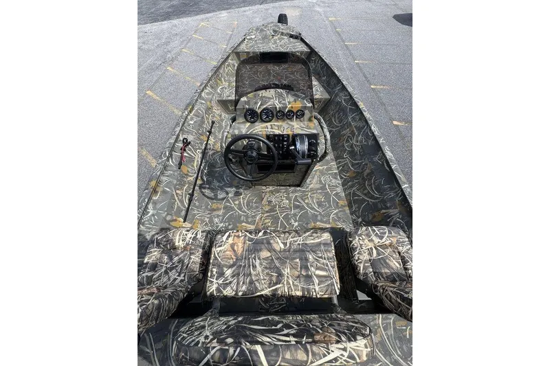 Slide: The Image of 2026 War Eagle 961 Blackhawk boat with camouflage interior and steering console. - 11