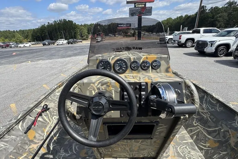 Slide: The Image of 2026 War Eagle 961 Blackhawk boat dashboard with camo design and control panel. - 13