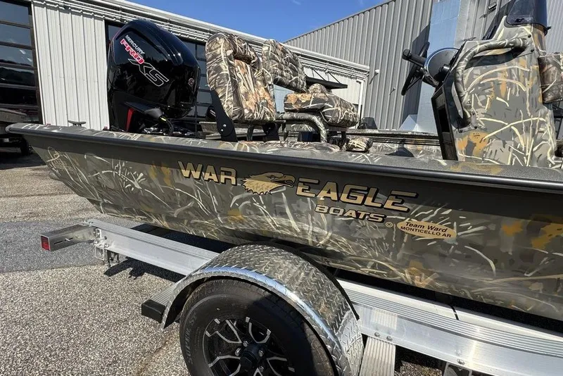 Slide: The Image of 2026 War Eagle 961 Blackhawk boat with camouflage design on a trailer. - 2