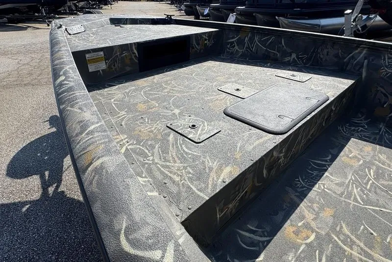 Slide: The Image of 2026 War Eagle 961 Blackhawk boat with camo pattern and storage compartments. - 5
