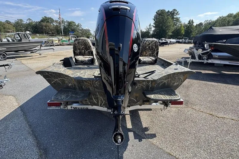 Slide: The Image of 2026 War Eagle 961 Blackhawk boat with camo design and powerful outboard motor. - 6