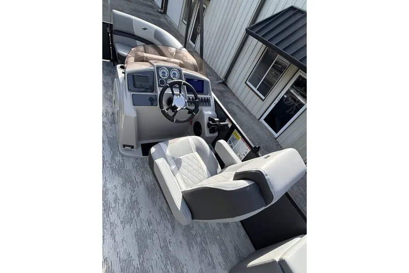 Slide: The Image of 2026 Starcraft EXS 1 Q DH boat interior with modern helm and seating. - 11
