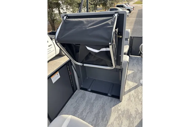 Slide: The Image of 2026 Starcraft EXS 1 Q DH boat interior with storage compartment open. - 15