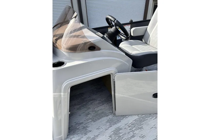 Slide: The Image of 2026 Starcraft EXS 1 Q DH boat interior with steering wheel and seating. - 16