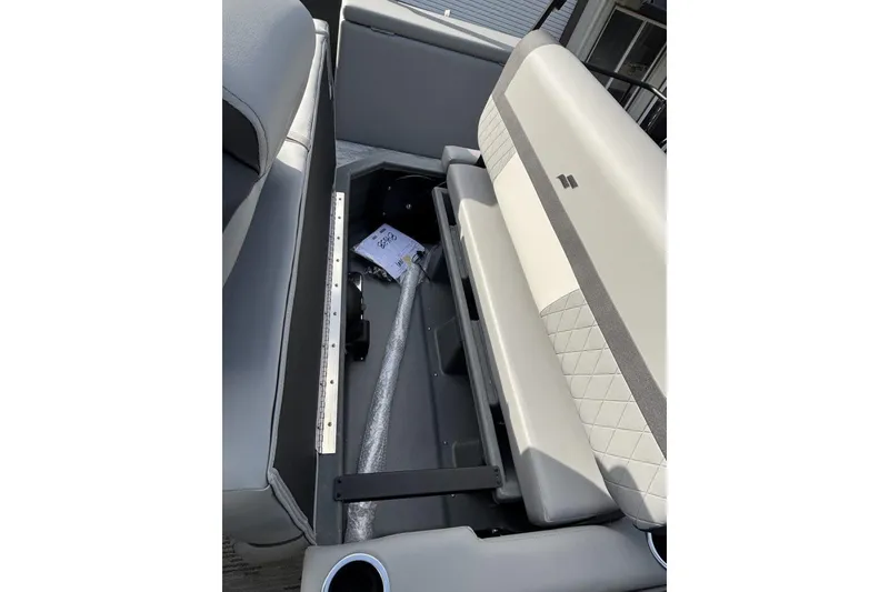 Slide: The Image of 2026 Starcraft EXS 1 Q DH boat interior storage compartment with cushioned seating. - 20
