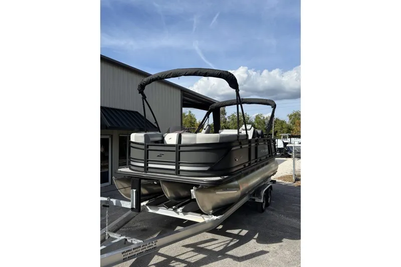Slide: The Image of 2026 Starcraft EXS 1 Q DH pontoon boat on trailer, parked outdoors. - 4