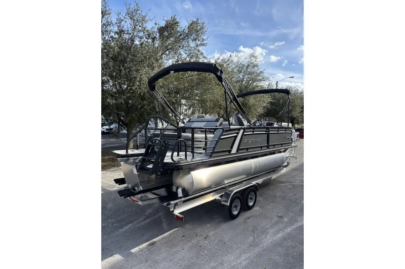 Slide: The Image of 2026 Starcraft EXS 1 Q DH pontoon boat on trailer, parked outdoors. - 8