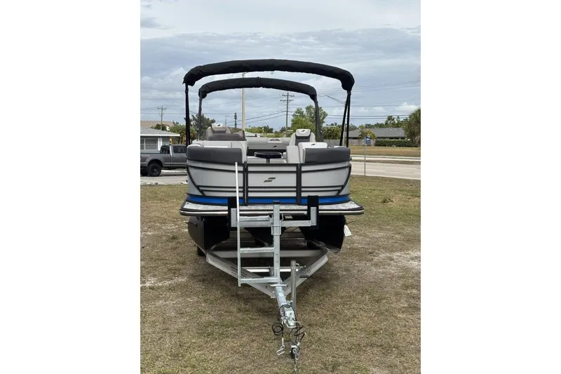 Slide: The Image of 2026 Starcraft SLS 3 Q DH boat on trailer, parked outdoors. - 5