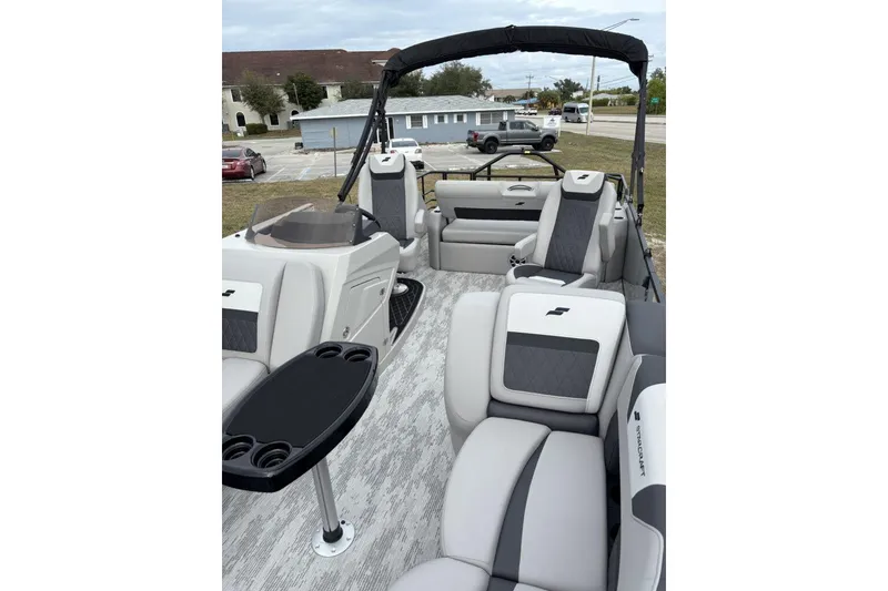 Slide: The Image of 2026 Starcraft SLS 3 Q DH boat helm with steering wheel and captain's chair. - 9