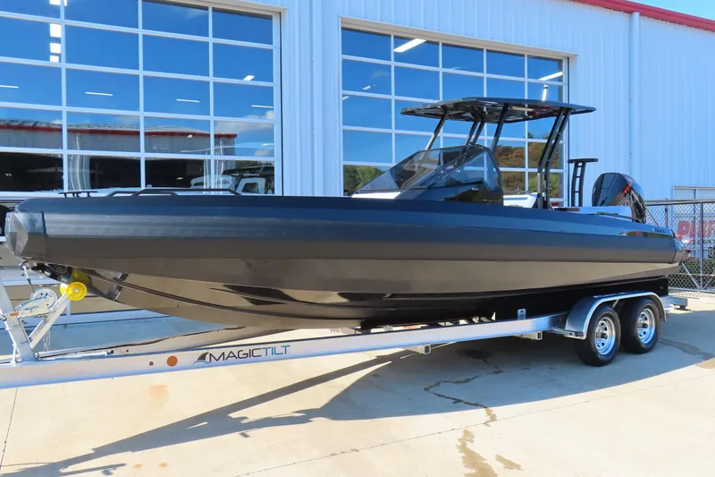 The Image of 2026 Iron 767 boat on trailer outside a modern building. - 1