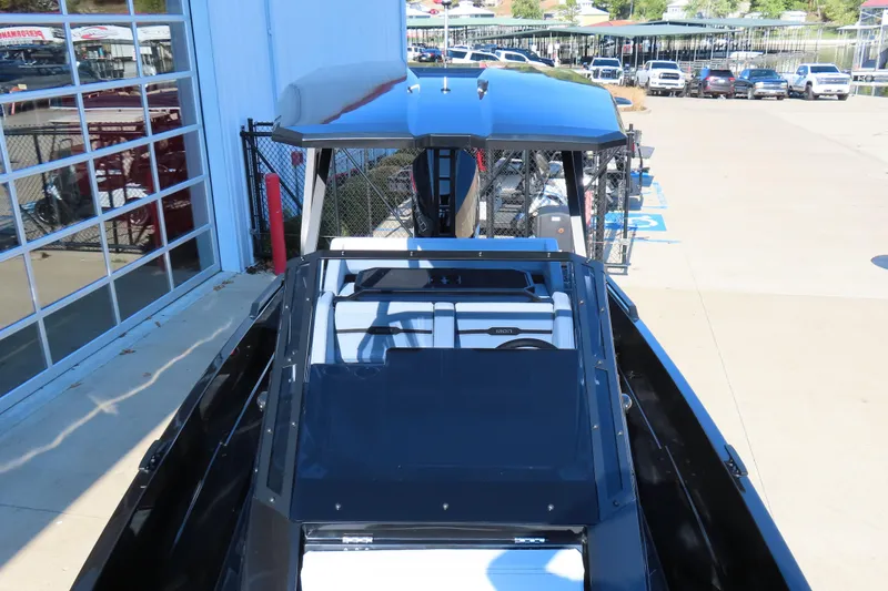 Slide: The Image of 2026 Iron 767 boat docked near a marina, showcasing sleek design and modern features. - 14