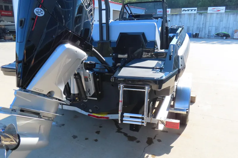 Slide: The Image of Rear view of 2026 Iron 767 boat with outboard motor and ladder on trailer. - 25