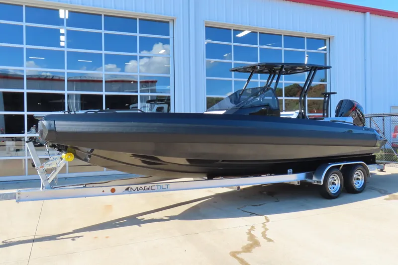 Slide: The Image of 2026 Iron 767 boat on trailer outside a modern building. - 3