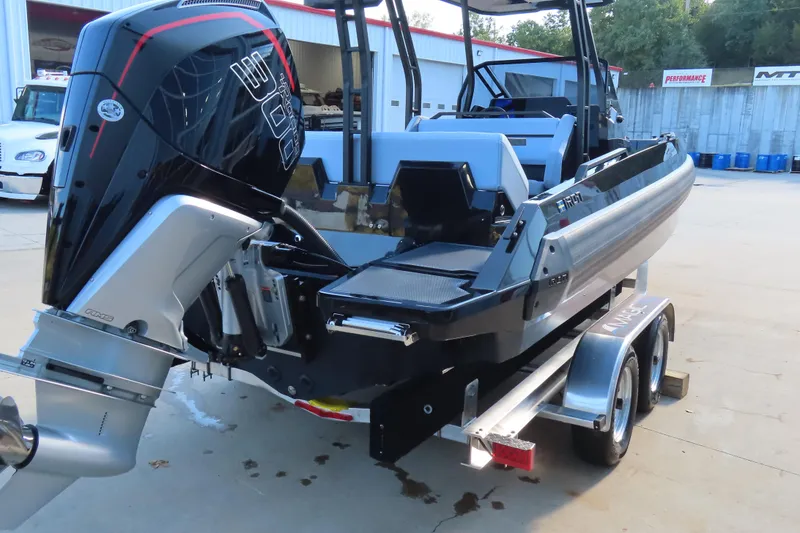 Slide: The Image of 2026 Iron 767 boat on trailer with powerful outboard motor in a parking area. - 8