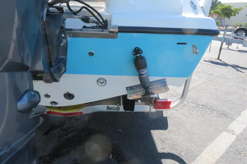 Slide: The Image of 2022 Key West 189 FS boat rear view with motor and trailer attachment. - 12