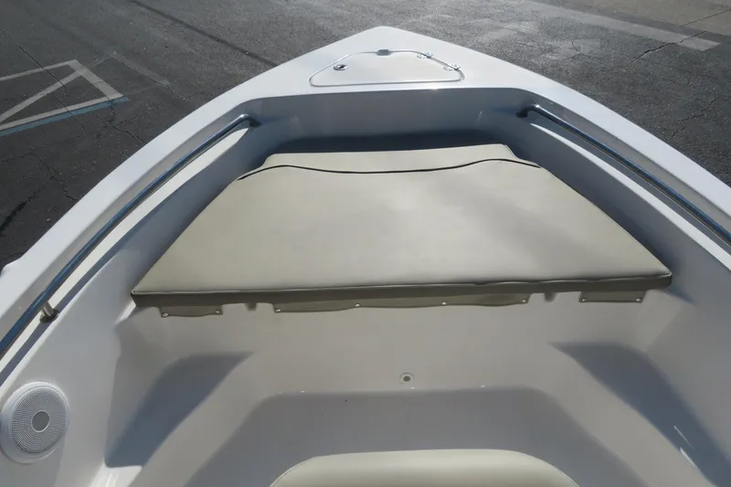 Slide: The Image of 2022 Key West 189 FS boat bow with cushioned seating and storage compartment. - 13