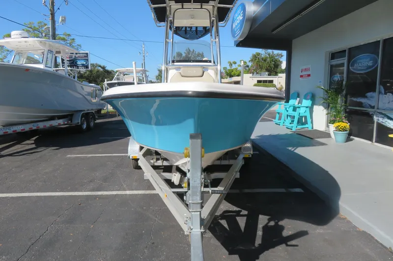 Slide: The Image of 2022 Key West 189 FS boat on trailer outside marine shop. - 2