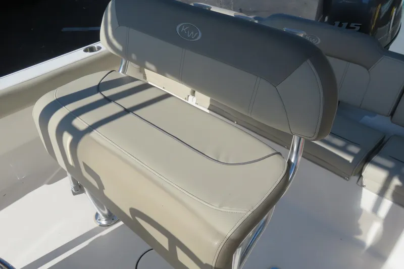 Slide: The Image of 2022 Key West 189 FS boat seat with beige upholstery and stainless steel frame. - 21