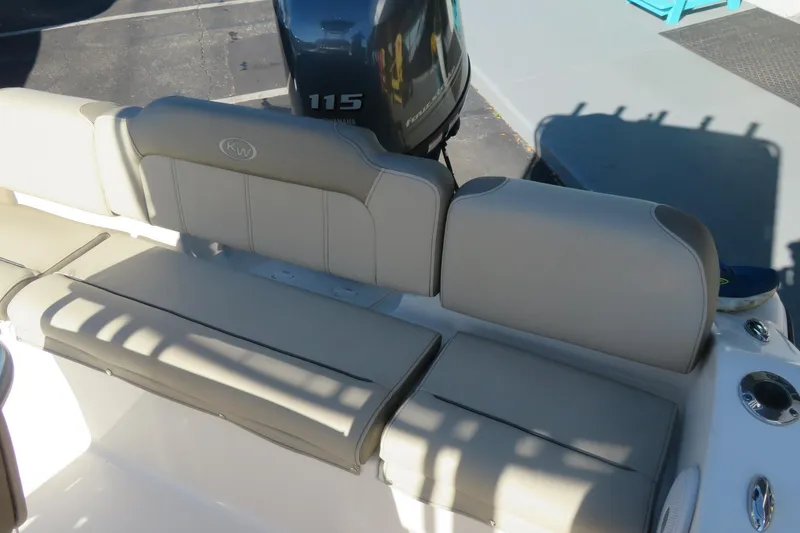Slide: The Image of 2022 Key West 189 FS boat interior with beige seating and Yamaha 115 engine. - 22
