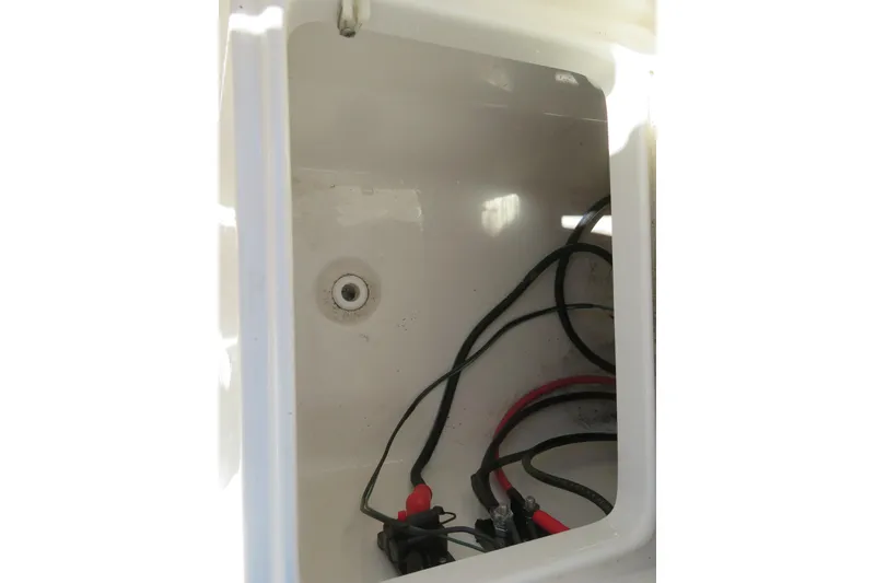 Slide: The Image of 2022 Key West 189 FS boat compartment with wiring and drainage. - 23