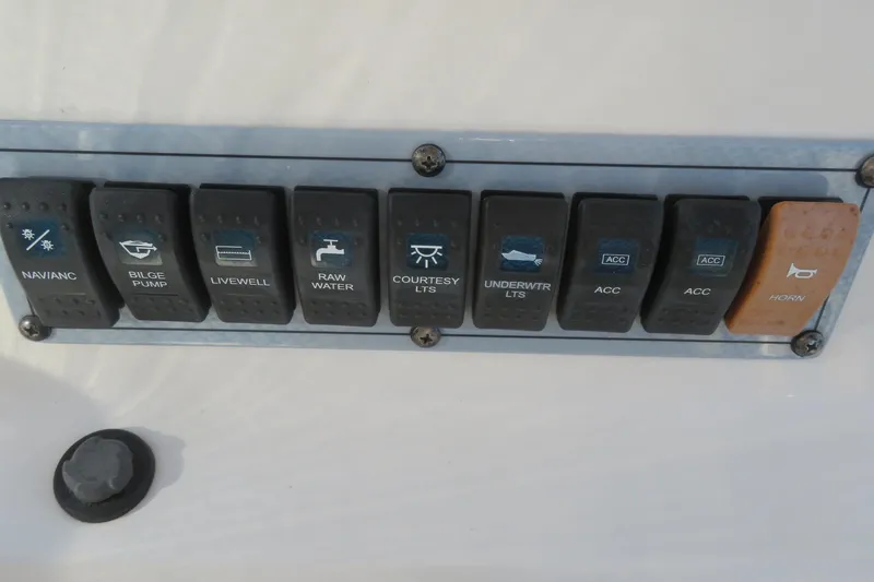 Slide: The Image of Control panel of a 2022 Key West 189 FS boat with labeled switches. - 30