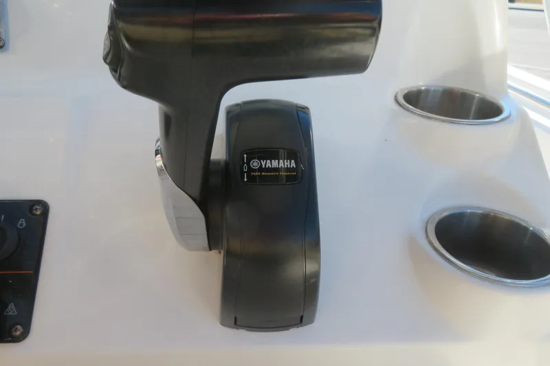 Slide: The Image of Yamaha throttle control on 2022 Key West 189 FS boat dashboard with cup holders. - 34