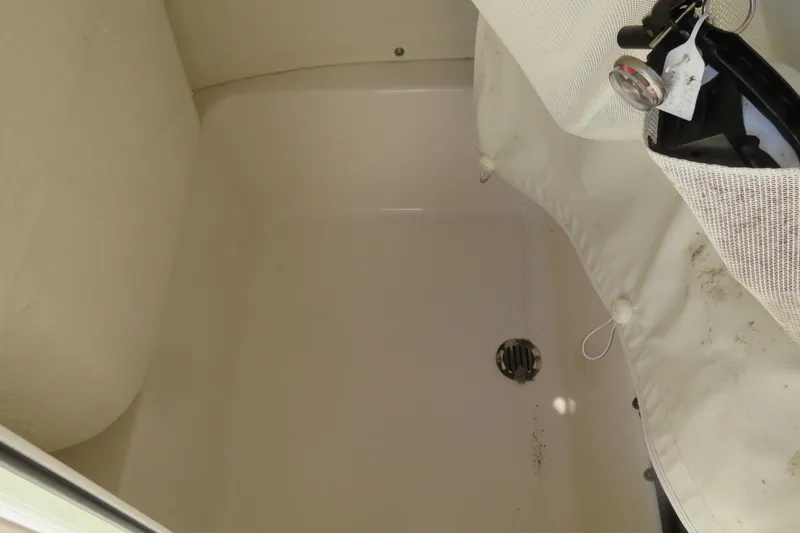 Slide: The Image of 2022 Key West 189 FS boat storage compartment with drain and mesh bag. - 37