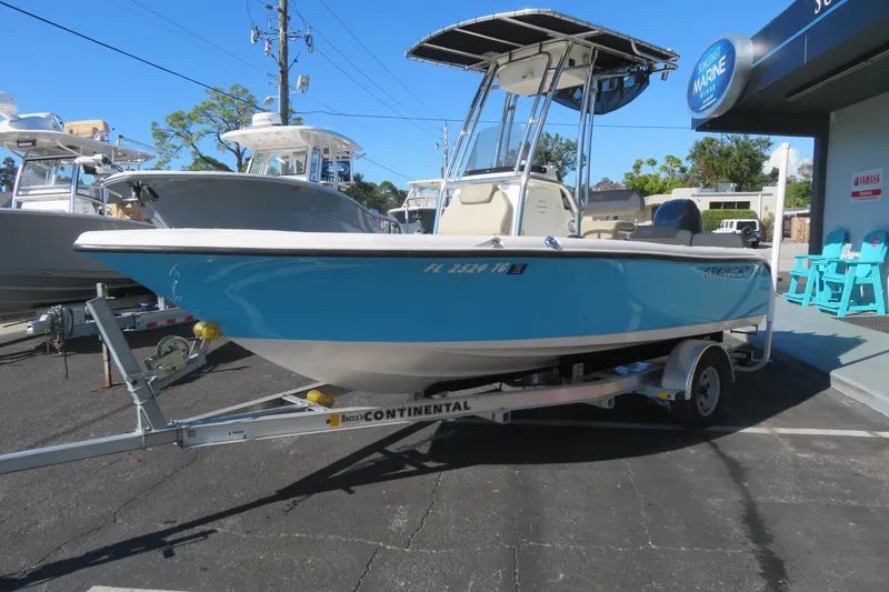 Slide: The Image of 2022 Key West 189 FS boat on trailer at dealership, blue hull, sunny day. - 4