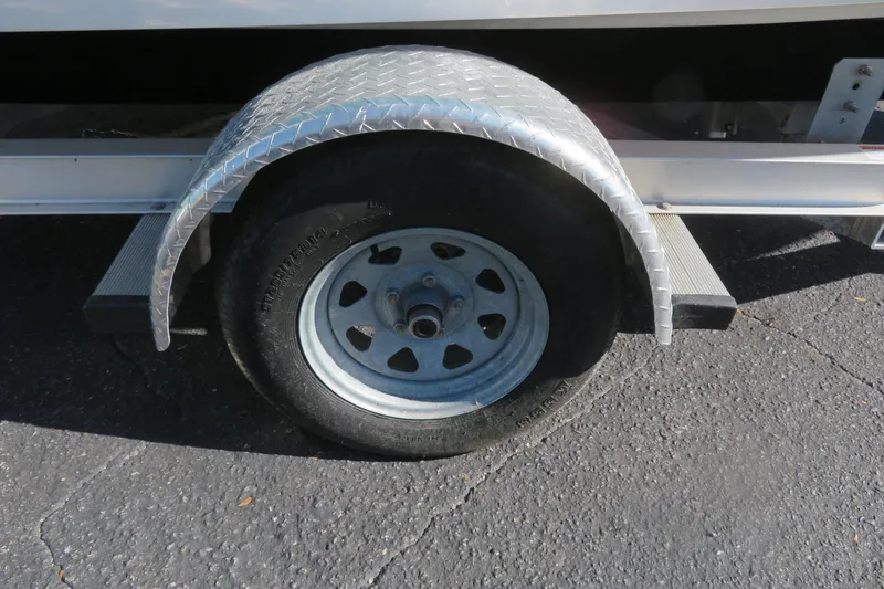 Slide: The Image of Trailer wheel and fender of 2022 Key West 189 FS boat on asphalt. - 42