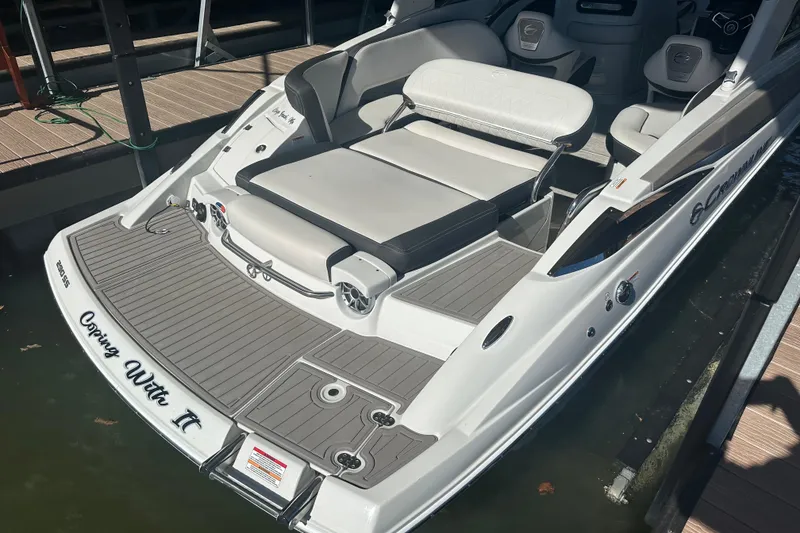 Slide: The Image of 2023 Crownline 290 CR boat with spacious seating and sleek design at a dock. - 10