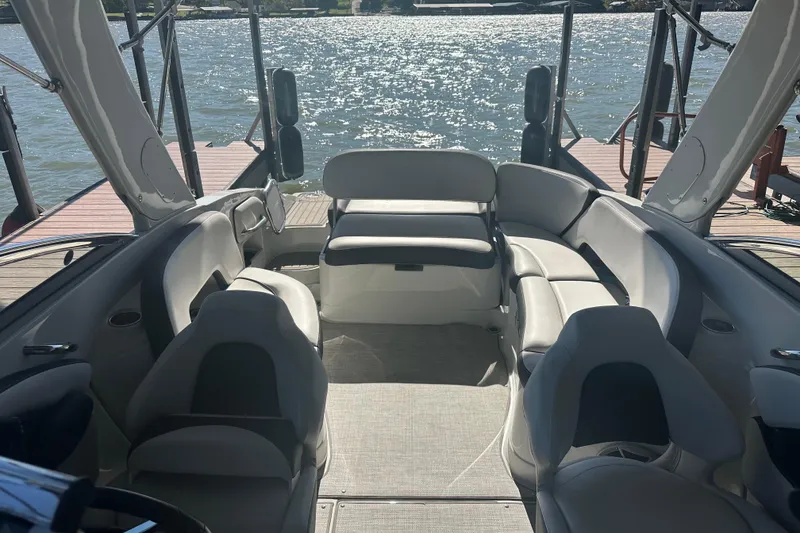 Slide: The Image of 2023 Crownline 290 CR boat interior with spacious seating and lake view. - 13