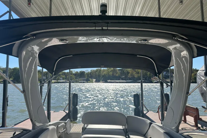 Slide: The Image of 2023 Crownline 290 CR boat interior with lake view under a canopy. - 15