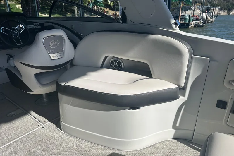Slide: The Image of 2023 Crownline 290 CR boat interior with steering wheel and seating area. - 16