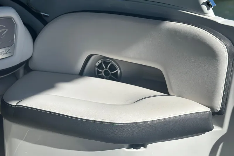 Slide: The Image of 2023 Crownline 290 CR boat interior with cushioned seating and speaker detail. - 17